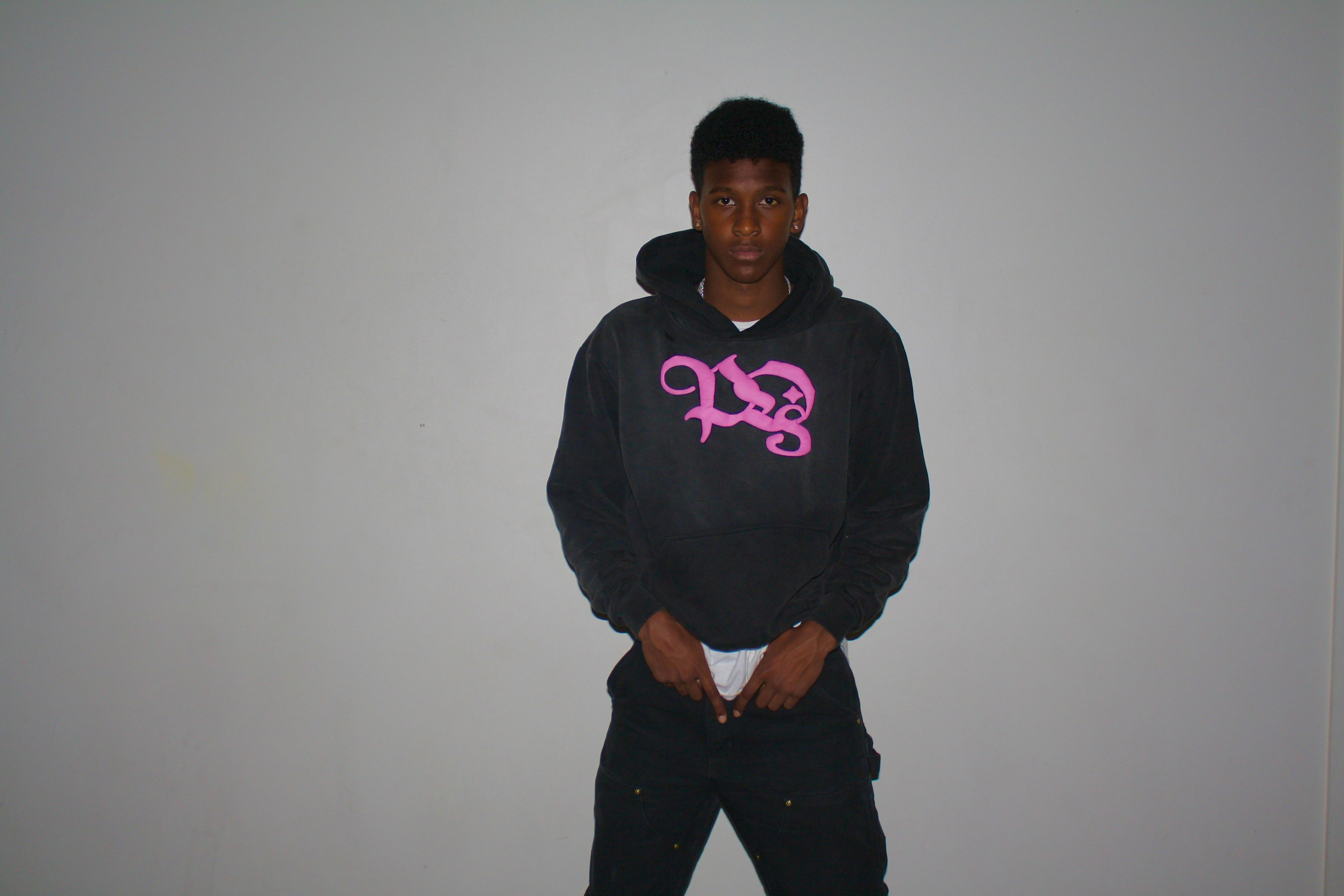 Stand Out Collective pink logo hoodie being modeled